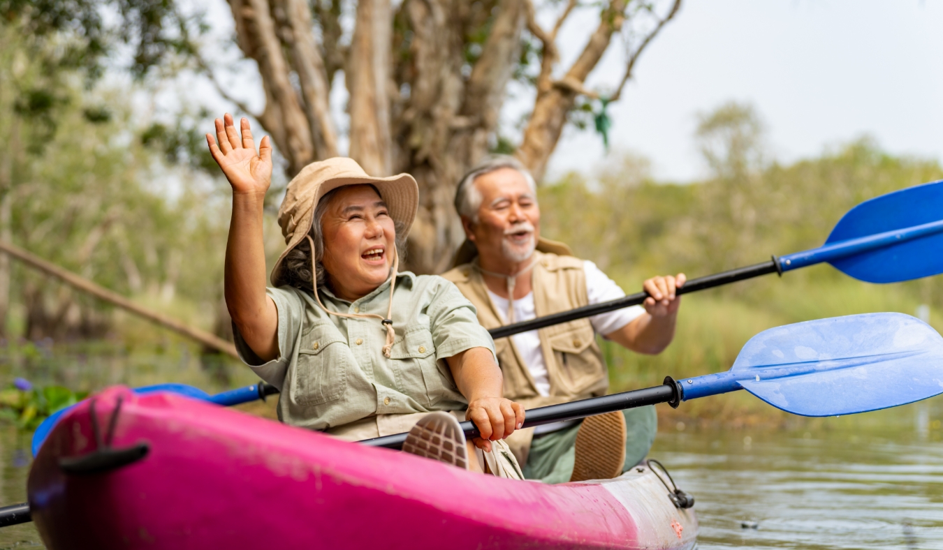 senior couple kayaking together in the lake