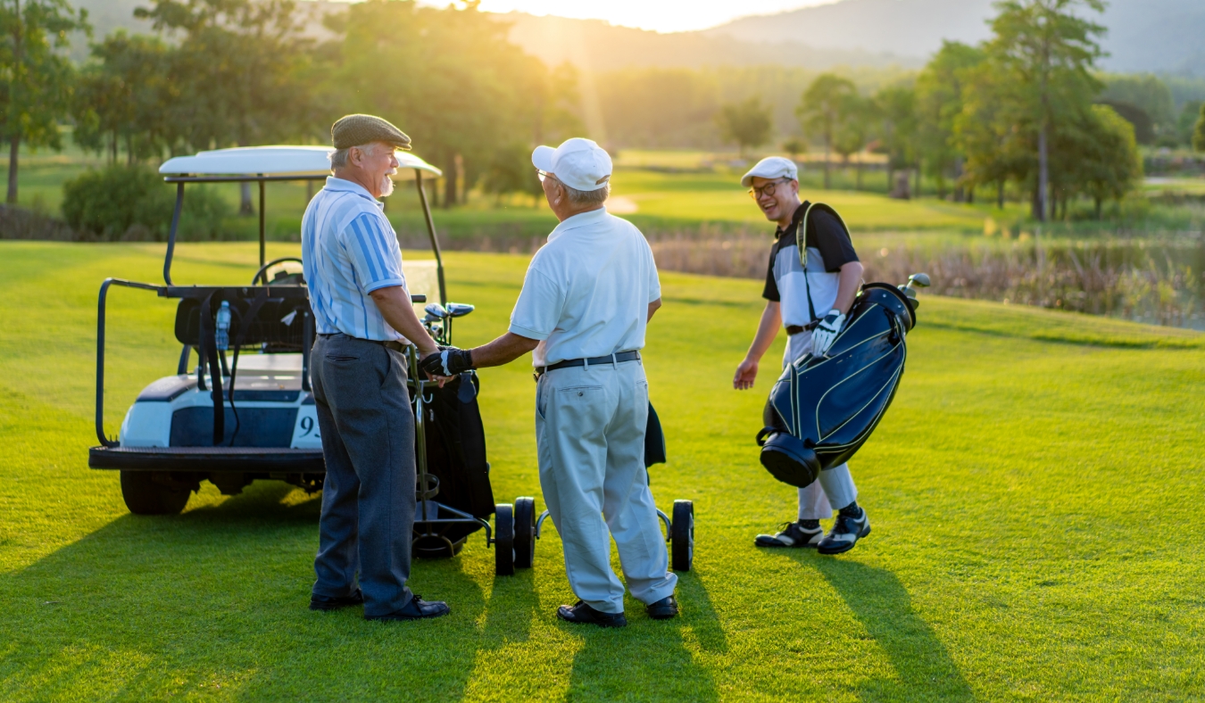 Healthy men golfer shaking hand after finish game on golf course at summer