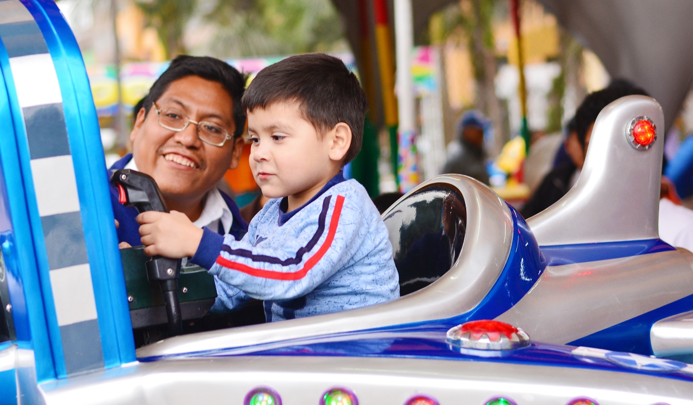 Native american man with his little son in the amusement park