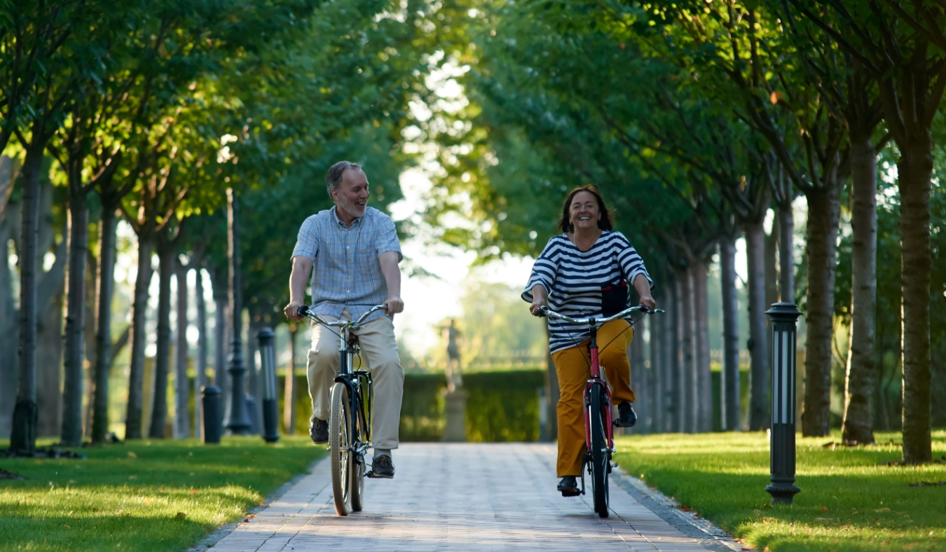 retired couple cyling in the park