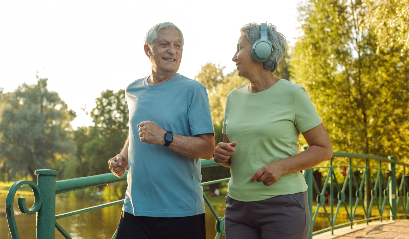 Smiling senior couple jogging in the park