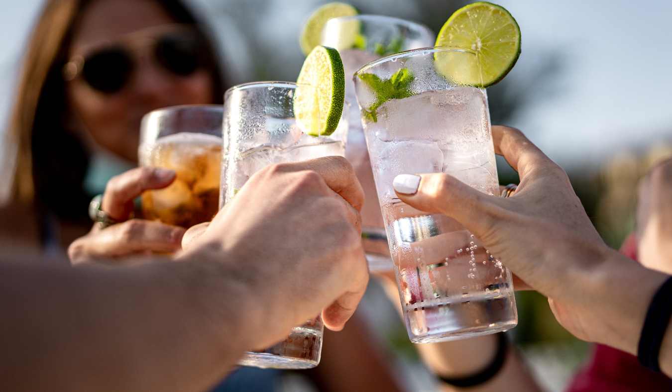 young people clinking iced cold drinks