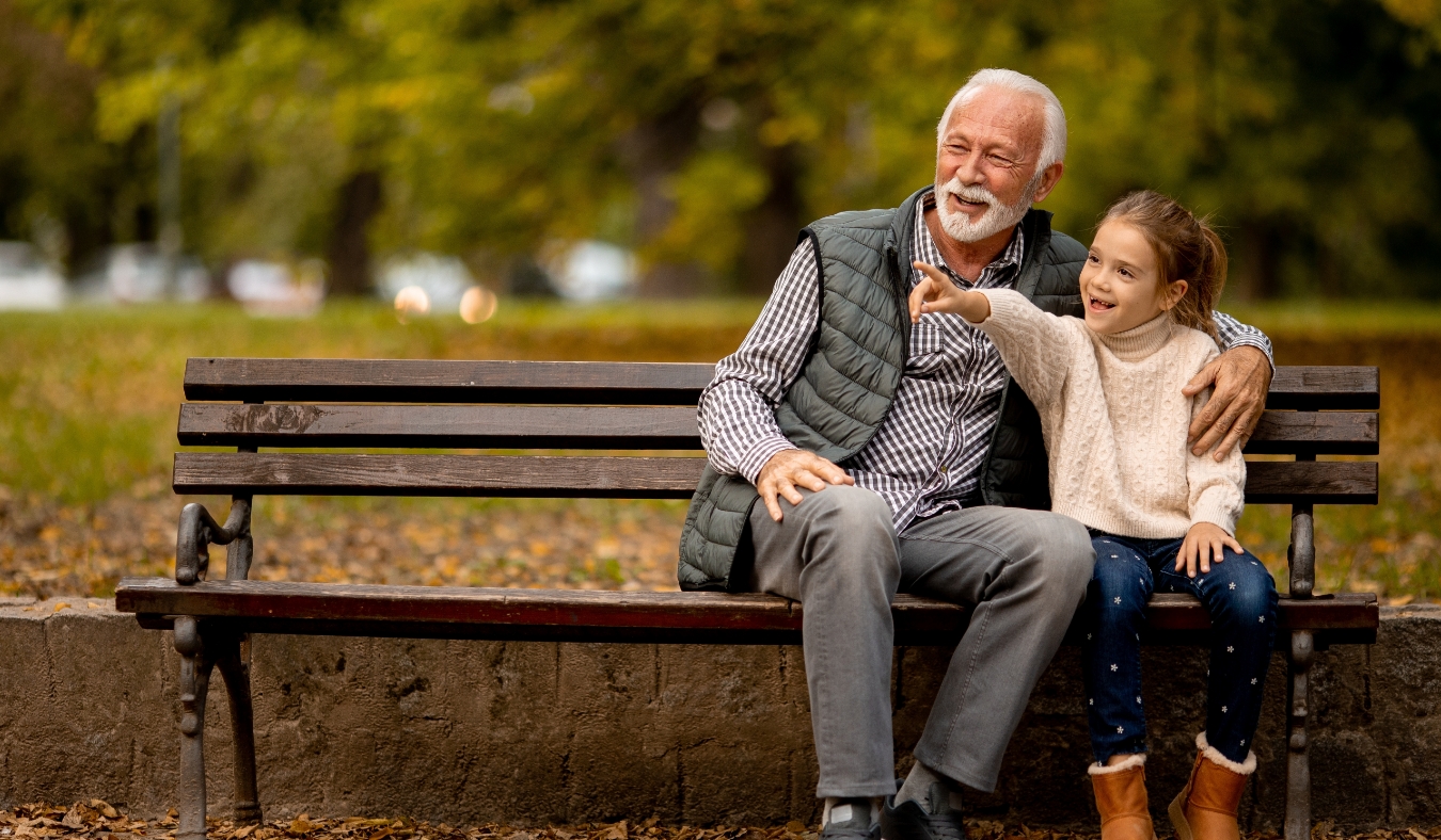 grandfather spending time with his granddaughter in park