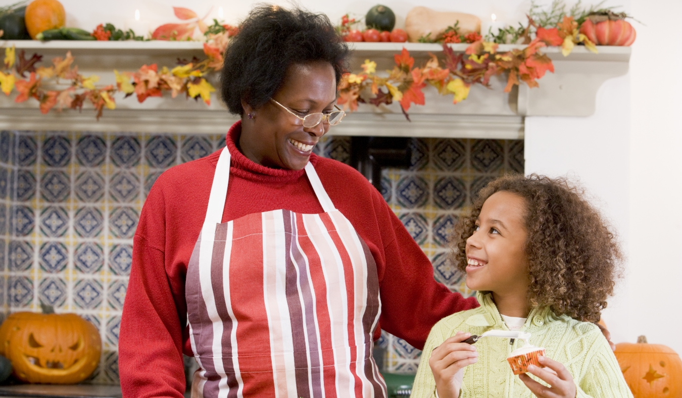 grandmother and granddaughter baking halloween treats