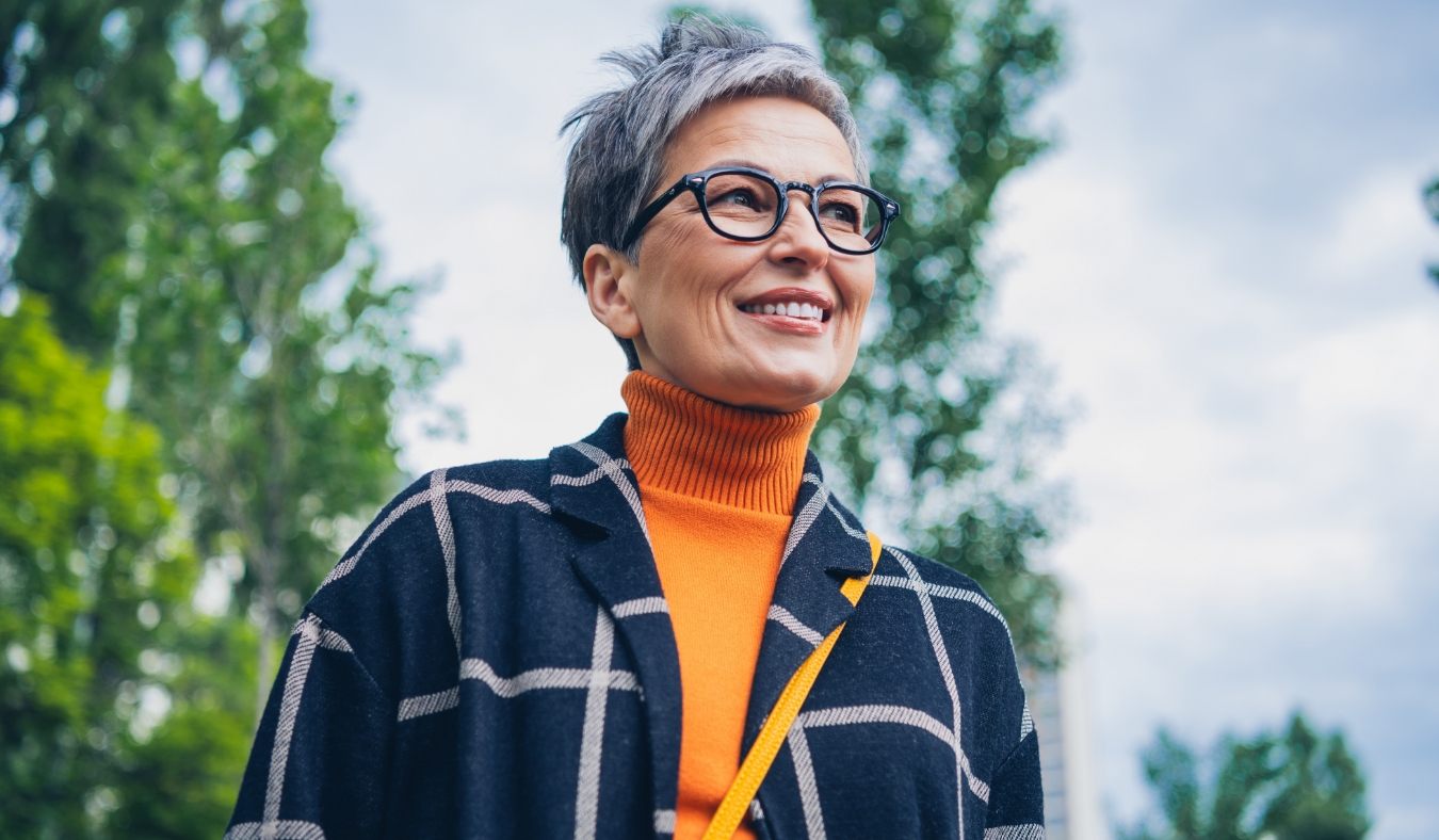 middle aged woman dressed for autumn weather smiling