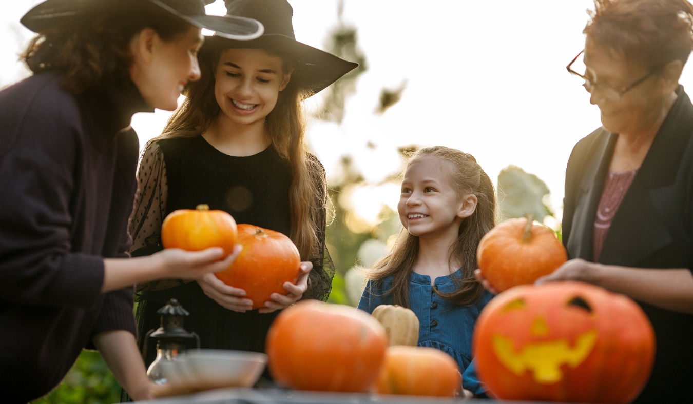 multigenerational family carving pumpkins
