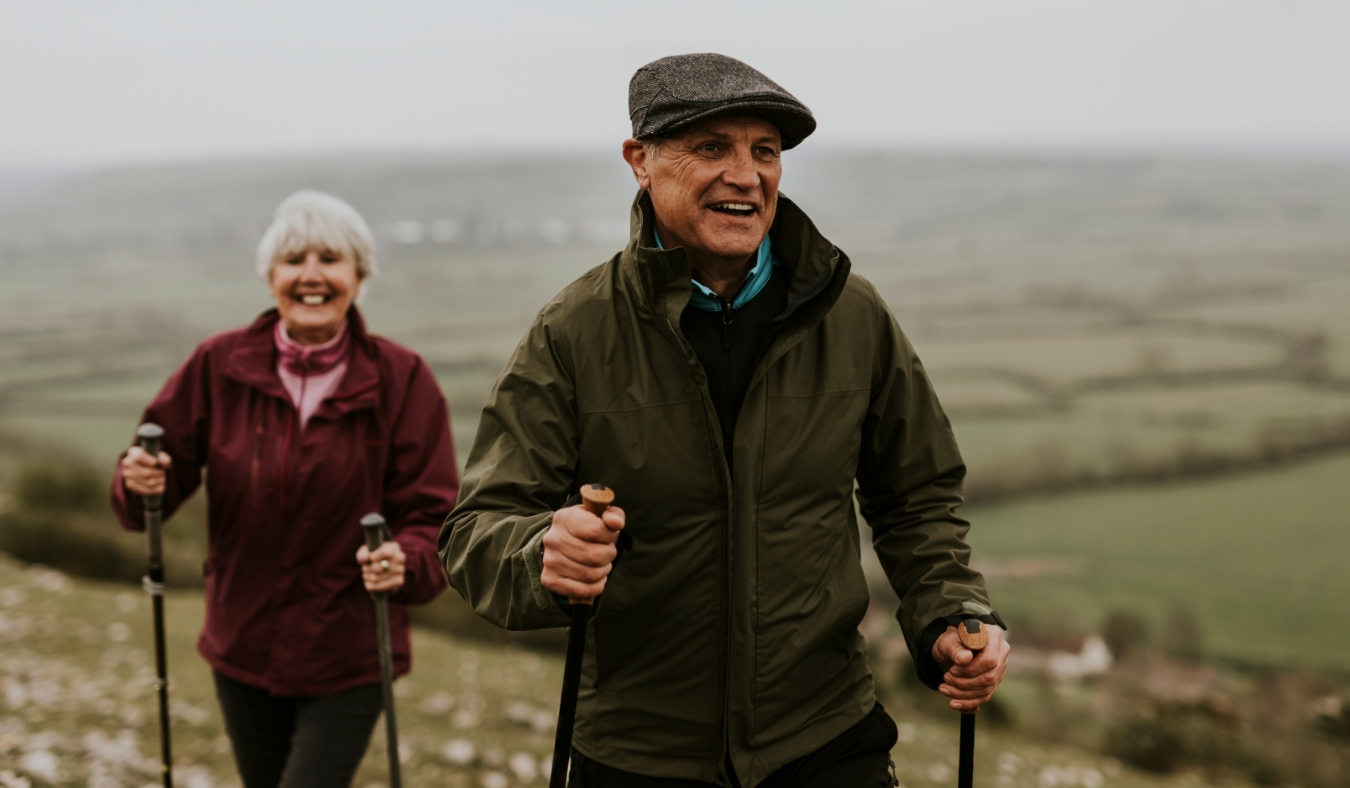 senior couple hiking in early autumn morning
