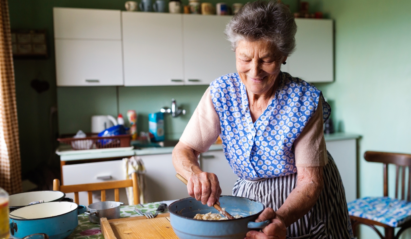 senior woman baking pies in her home kitchen