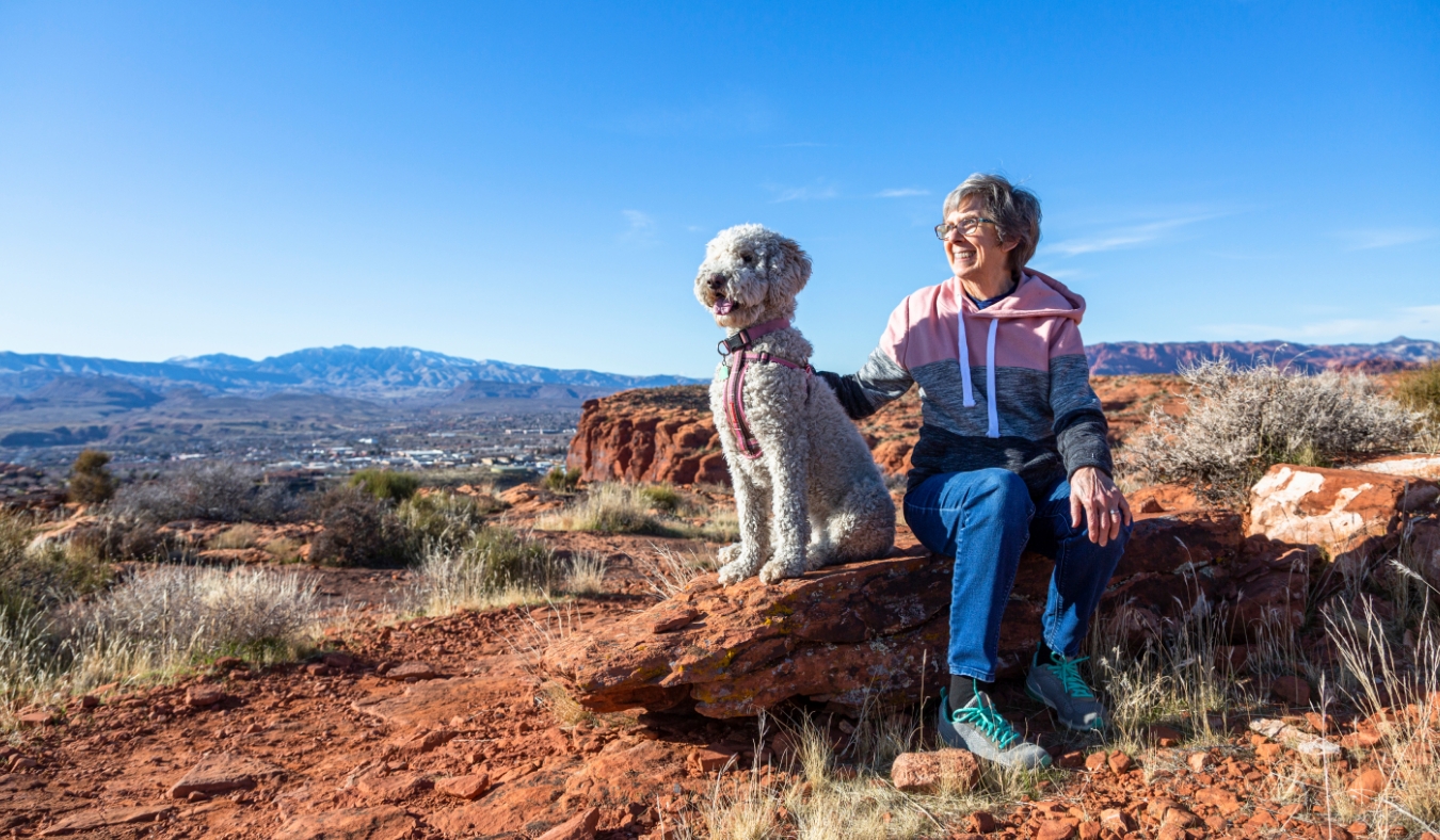 senior woman on an outdoor hike with her dog in autumn