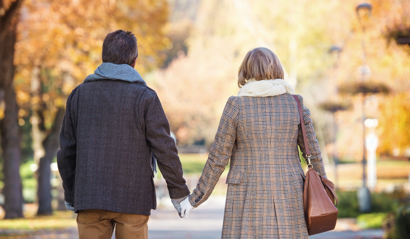 active seniors on a walk in a town park