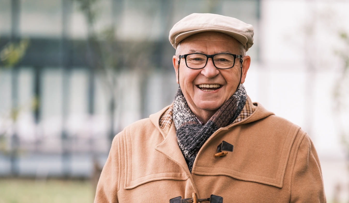 cheerful senior man in winter coat