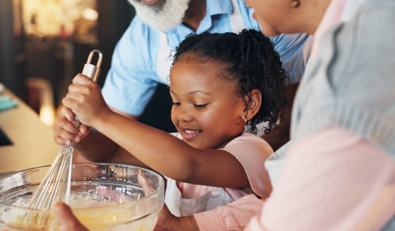granddaughter mixing dough for holiday treats