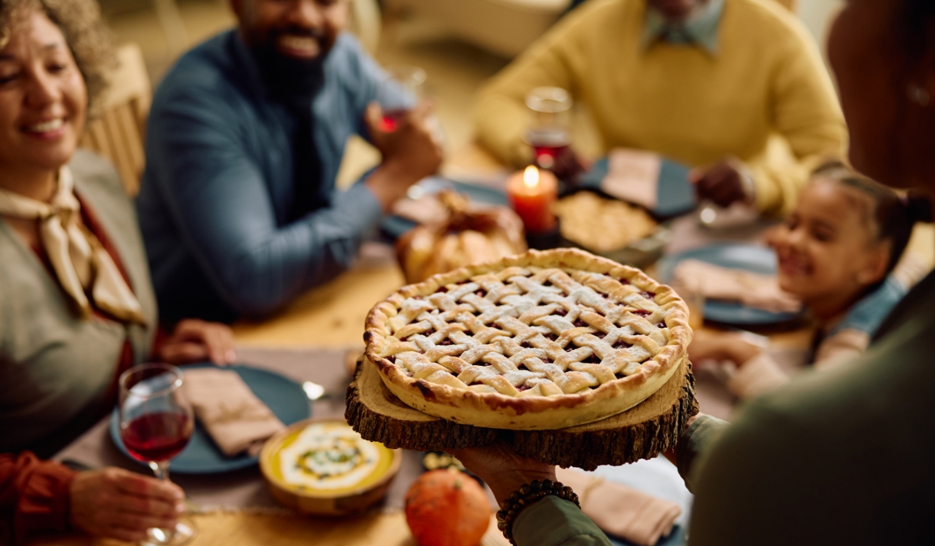 grandmother serving fresh pie during dinner