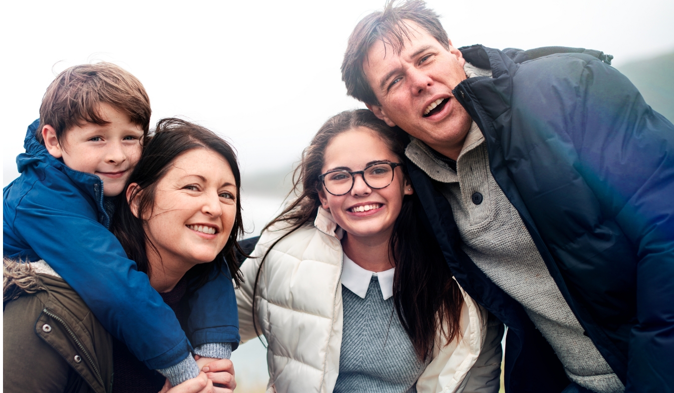 family smiling on a chilly day