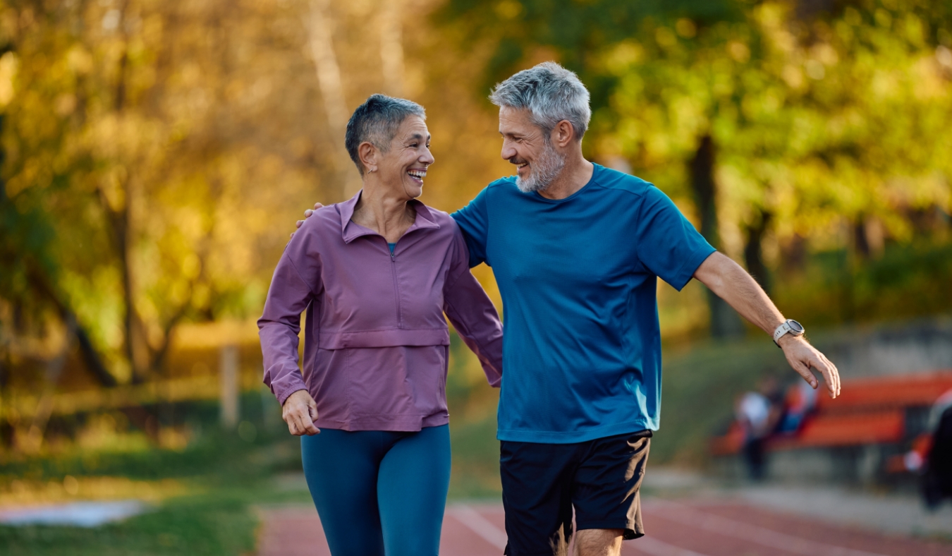 senior active couple walking outside during early fall