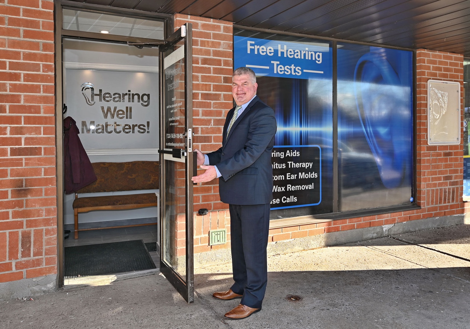 Rob Hamilton opening front door to clinic in column