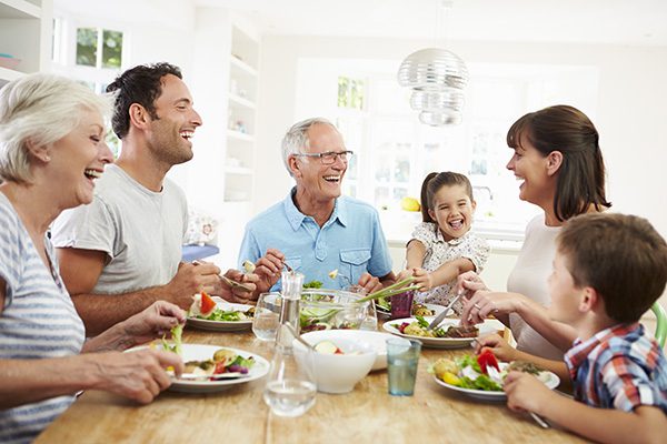 man with hearing loss eating dinner with family in home